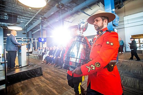 MIKAELA MACKENZIE / WINNIPEG FREE PRESS

RCMP carry the Grey Cup into a press conference at IG Field in Winnipeg on Tuesday, March 14, 2023. For Jeff story.

Winnipeg Free Press 2023.