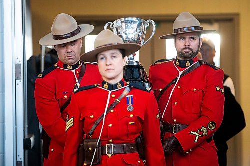 MIKAELA MACKENZIE / WINNIPEG FREE PRESS

RCMP carry the Grey Cup into a press conference at IG Field in Winnipeg on Tuesday, March 14, 2023. For Jeff story.

Winnipeg Free Press 2023.