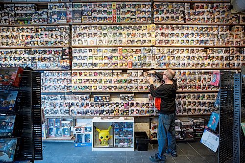 MIKE DEAL / WINNIPEG FREE PRESS
Les David arranges some of the hundreds of new-in-box Funko Pops! (a highly sought-out line of vinyl figurines) on a wall at his new South Osborne shop, Hollywood Toy and Poster Company.
