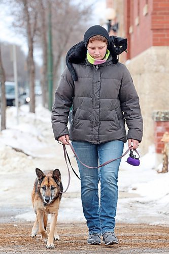 Lily Dyck enjoys a walk with her cat Lucy and her dog Coral along Princess Avenue on a mild Wednesday. (Tim Smith/The Brandon Sun)