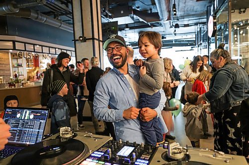 RUTH BONNEVILLE / WINNIPEG FREE PRESS &#x2028;
NT - kids dance party

Photo of Justin Navarrette with his son Nolan (3yrs), talking and laughing with the DJ at the party Saturday. 

Wacky Doodle Dance Party DJs along with party goers dancing at Hargrave Street Market.  Story is a review of a dance party for kids.


Story by AV Kitching


March 11th, 2023

