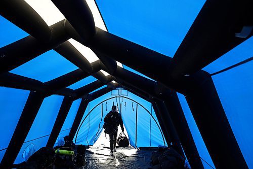 15032022
Cpl. Kathryn Ternier, the Recovery Team Coordinator with RCMP D Division in Winnipeg enters the tent during ice diving re-qualification for members of Manitoba and Saskatchewan&#x2019;s RCMP dive teams at Clear Lake in Riding Mountain National Park on Tuesday. 
(Tim Smith/The Brandon Sun)