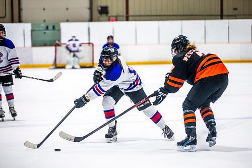 MIKAELA MACKENZIE / WINNIPEG FREE PRESS

Churchill Bulldog Selene Wozney (19) and CSLR Renard Gabrielle Westendorf (7) go for the puck in the fateful Game 3 of the Manitoba Women&#x573; High School Hockey League Division 1 championship at Dakota Community Centre in Winnipeg on Wednesday, March 15, 2023. For Josh story.

Winnipeg Free Press 2023.