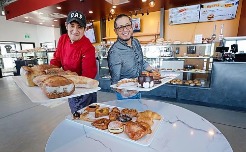 RUTH BONNEVILLE / WINNIPEG FREE PRESS 

ENT - Charito Bakery

Portrait of Charito Bakery owner, Armando Sanchez (right) with his brother, Jorge Sanchez, who works in the bakery holding a variety of treats like, sourdough breads, cakes, cream filled croissants and donuts. 

SKED LINE: New Canadian Media profile about an Ecuadorian family-run bakery, Charito Bakery that entices Winnipeg neighbourhood in Sage Creek with Latin American desserts.

Owner, Armando Sanchez moved to Winnipeg from Ecuador to continue his family&#x573; baking legacy. Charito just turned one year old in February 2023.
 Charito Bakery &amp; Pastry, 55 Sage Creek 

REPORTER: NCM Reporter, Javier Ortega-Araiza 

March 13th, 2023

