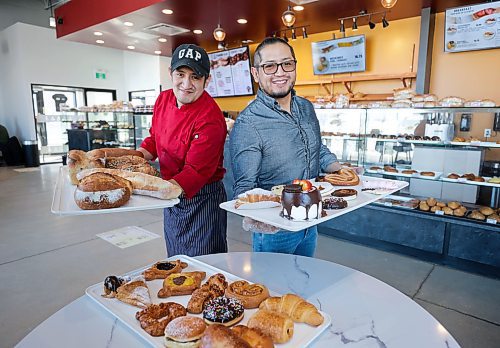 RUTH BONNEVILLE / WINNIPEG FREE PRESS 

ENT - Charito Bakery

Portrait of Charito Bakery owner, Armando Sanchez (right) with his brother, Jorge Sanchez, who works in the bakery holding a variety of treats like, sourdough breads, cakes, cream filled croissants and donuts. 

SKED LINE: New Canadian Media profile about an Ecuadorian family-run bakery, Charito Bakery that entices Winnipeg neighbourhood in Sage Creek with Latin American desserts.

Owner, Armando Sanchez moved to Winnipeg from Ecuador to continue his family&#x573; baking legacy. Charito just turned one year old in February 2023.
 Charito Bakery &amp; Pastry, 55 Sage Creek 

REPORTER: NCM Reporter, Javier Ortega-Araiza 

March 13th, 2023

