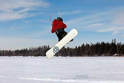 Ryan Murray of Onanole catches air while snowkiting at Clear Lake in Riding Mountain National Park on a windy Tuesday afternoon. Murray offers snowkiting lessons through the Friends of Riding Mountain National Park. Snowkiting is using a kite and the power of the wind to glide across snow and ice on a snowboard. (Tim Smith/The Brandon Sun)