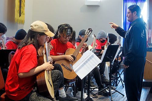 MIKE DEAL / WINNIPEG FREE PRESS
Jerimiah Knott (wearing a headband) with the Wasagamack First Nation School Guitar Orchestra performs Tuesday morning at the Fort Garry United Church, 800 Point Road, during the Winnipeg Music Festival.
The last time Wasagamack First Nation School Guitar Orchestra participated (2022) they received the Lieutenant Governor&#x2019;s Award for the most outstanding performance of the festival.
230307 - Tuesday, March 07, 2023.