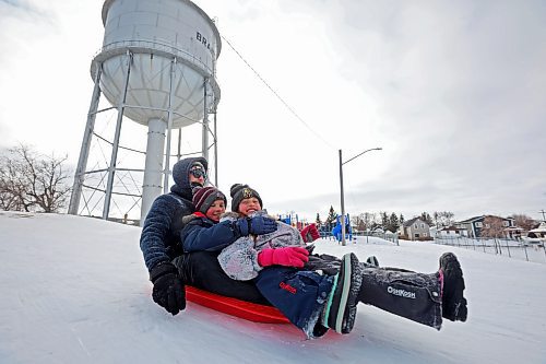 Geoff and his children Lukas and Elena (no last names given) toboggan at Rideau Park on Thursday afternoon. (Tim Smith/The Brandon Sun)