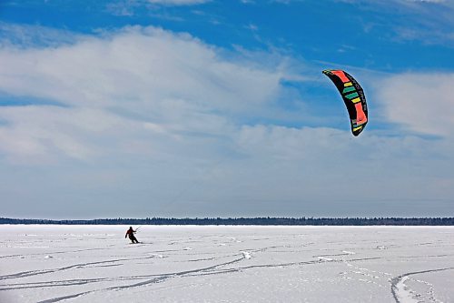14032023
Ryan Murray of Onanole snowkites across Clear Lake at Riding Mountain National Park on a windy Tuesday afternoon. Murray offers snowkiting lessons through the Friends of Riding Mountain National Park. Snowkiting is using a kite and the power of the wind to glide across snow and ice on a snowboard.  
(Tim Smith/The Brandon Sun)