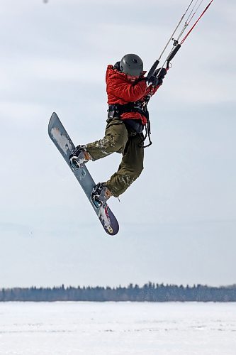 14032023
Ryan Murray of Onanole catches air while snowkiting at Clear Lake in Riding Mountain National Park on a windy Tuesday afternoon. Murray offers snowkiting lessons through the Friends of Riding Mountain National Park. Snowkiting is using a kite and the power of the wind to glide across snow and ice on a snowboard.  
(Tim Smith/The Brandon Sun)