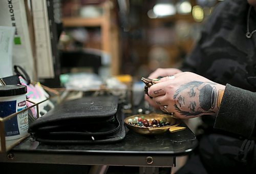 Delaney Tycholis, 29, who works in the restaurant industry and also runs a jewelry business under the brand Daisy Wild Vintage, is part of the millennials and generation Zs facing financial challenges these days. Tycholis is pictured working on jewerly at her home workshop. (Brook Jones / Winnipeg Free Press)