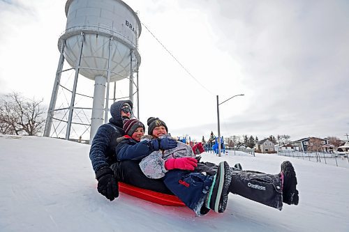 16032023
Geoff and his children Lukas and Elena (no last names given) toboggan at Rideau Park on a windy Thursday afternoon. 
(Tim Smith/The Brandon Sun)