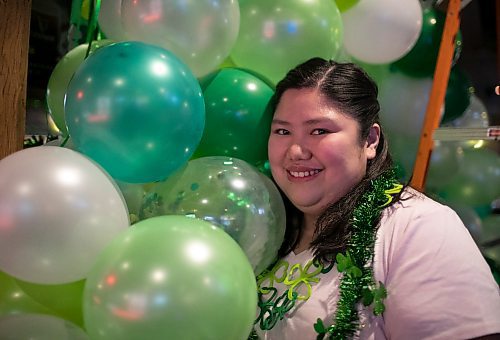 Kim Tan, who is the marketing director at the Thirsty Lion Tavern at 525 Dale Blvd., in Winnipeg, Man., decorates for the upcoming St. Patrick's Day bash, which gets underway at the local tavern at 7 p.m. March 17, 2023. (Brook Jones / Winnipeg Free Press)