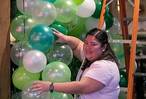 Kim Tan, who is the marketing director at the Thirsty Lion Tavern at 525 Dale Blvd., in Winnipeg, Man., decorates for the upcoming St. Patrick's Day bash, which gets underway at the local tavern at 7 p.m. March 17, 2023. (Brook Jones / Winnipeg Free Press)