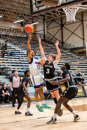 MIKAELA MACKENZIE / WINNIPEG FREE PRESS

Sturgeon Heights Husky Noah Kankam (13) tries for a shot as Vincent Massey Trojan Joshua Lamoureux (3) blocks in the boy's AAAA provincial semi-finals at Investors Group Athletic Centre in Winnipeg on Thursday, March 16, 2023. For Josh story.

Winnipeg Free Press 2023.