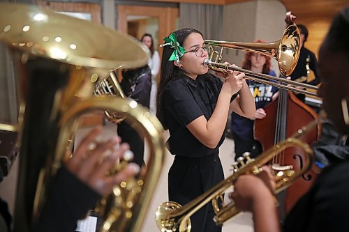 Lyla Briol with Brandon’s Vincent Massey High School Junior Jazz Band plays the trombone with St. Patrick’s Day bows in her hair while warming up with band-mates prior to performing during the Brandon University Jazz Festival at the Brandon University School of Music on Friday. The three day festival, the first since 2019 due to the COVID-19 pandemic, brought in school bands from across the province for performances and workshops throughout the WMCA and Brandon University. The festival wraps up today.
(Tim Smith/The Brandon Sun)