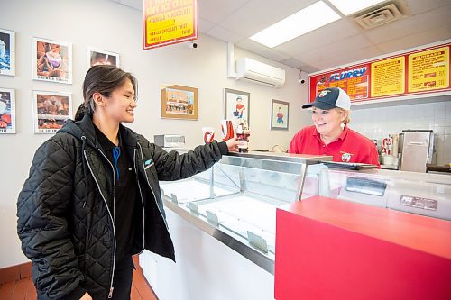 Mike Sudoma/Winnipeg Free Press
Lynn Dusessoy of Sargeant Sundae serves up a sundae to Maria Canteras Friday afternoon as the ice cream shop opens its once doors again after a cold winter off
March 17, 2023 