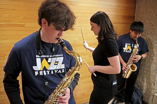 17032023
Percussionist Devin Kerman-Forsythe keeps the beat on the wall while warming up with band-mates in Brandon&#x2019;s Vincent Massey High School Junior Jazz Band prior to performing during the Brandon University Jazz Festival at the Brandon University School of Music on Friday. The three day festival, the first since 2019 due to the COVID-19 pandemic, brought in school bands from across the province for performances and workshops throughout the WMCA and Brandon University. The festival wraps up today. 
(Tim Smith/The Brandon Sun)