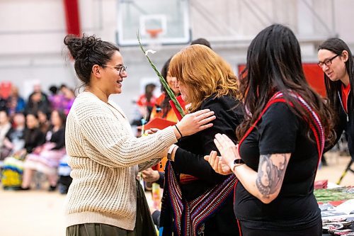 MIKAELA MACKENZIE / WINNIPEG FREE PRESS

Athena Le Fort-Lynx, bachelor of criminal justice graduate, shakes hands with Aboriginal Student Services Coordinator Tanis McLeod Kolisnyk at the U of W graduation Pow Wow at the Duckworth Centre in Winnipeg on Saturday, March 18, 2023. For Tyler story.

Winnipeg Free Press 2023.