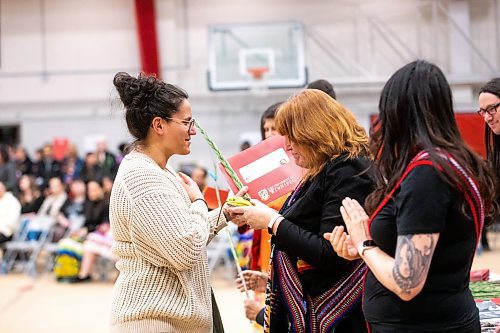 MIKAELA MACKENZIE / WINNIPEG FREE PRESS

Athena Le Fort-Lynx, bachelor of criminal justice graduate, shakes hands with Aboriginal Student Services Coordinator Tanis McLeod Kolisnyk at the U of W graduation Pow Wow at the Duckworth Centre in Winnipeg on Saturday, March 18, 2023. For Tyler story.

Winnipeg Free Press 2023.