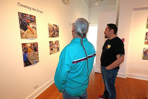 Frank Tacan and Jason Gobeil check out some of the "A Warrior's Red Road" photos on display at the Glen P. Sutherland Gallery of Art Sunday afternoon. The exhibit will officially be open to the public on Tuesday night. (Kyle Darbyson/The Brandon Sun)