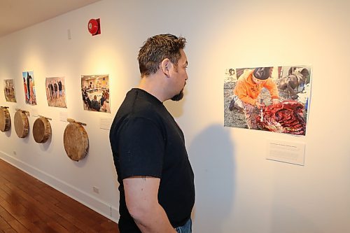 Jason Gobeil checks out some of the "A Warrior's Red Road" photos on display at the Glen P. Sutherland Gallery of Art Sunday afternoon. The exhibit will officially be open to the public on Tuesday night (Kyle Darbyson/The Brandon Sun)
