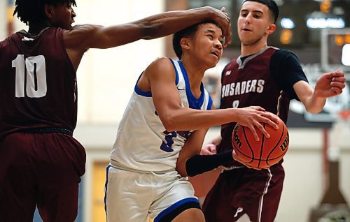 JOHN WOODS / WINNIPEG FREE PRESS
St Paul&#x2019;s Crusaders&#x2019; Giovanni Ajiamah (10) defends against Sturgeon Heights Huskies&#x2019; Joash Rocaberte (3) in the Manitoba High School 2023 AAAA Provincial Basketball Championship at the University of Manitoba Monday, March 20, 2023. 