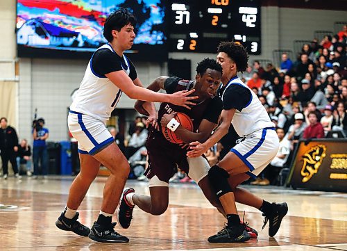 JOHN WOODS / WINNIPEG FREE PRESS
Sturgeon Heights Huskies&#x2019; Luciano Glades (10) and Elijah De La Mothe (6) defend against St Paul&#x2019;s Crusaders&#x2019; Ramogy Nyagudi (14) in the Manitoba High School 2023 AAAA Provincial Basketball Championship at the University of Manitoba Monday, March 20, 2023. 