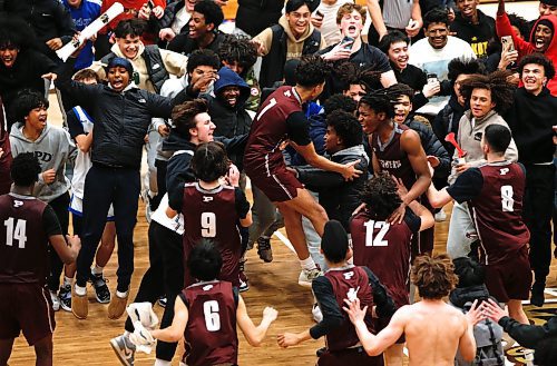 JOHN WOODS / WINNIPEG FREE PRESS
St Paul&#x2019;s Crusaders celebrate a win over the Sturgeon Heights Huskies in the Manitoba High School 2023 AAAA Provincial Basketball Championship at the University of Manitoba Monday, March 20, 2023. 