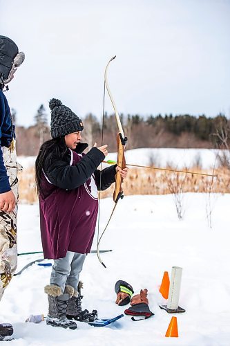 MIKAELA MACKENZIE / WINNIPEG FREE PRESS

Shanaya Green loads an arrow in the archery portion of the snowshoe races (a land-based part of the winter carnival festivities at Bloodvein River School) on Bloodvein First Nation on Thursday, March 9, 2023. For Maggie Macintosh story.

Winnipeg Free Press 2023.