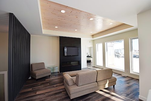 Photos by Todd Lewys / Winnipeg Free Press
Defined subtly by a vertical slat feature wall and tray ceiling, the family room is a well-defined space that offers a perfect combination of natural light and inviting warmth.