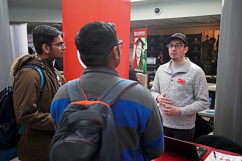 Lucas Roth, a traffic technician with ATS Traffic, talks to Brandon University students during the Summer Job Fair 2023 in the Knowles Douglas Student Union Centre on Wednesday. (Tim Smith/The Brandon Sun)