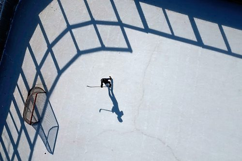 22032023
Andre Pashe casts a shadow as he practices his shots on net at the Central Community Club rink on a sunny Wednesday afternoon. 
(Tim Smith/The Brandon Sun)default