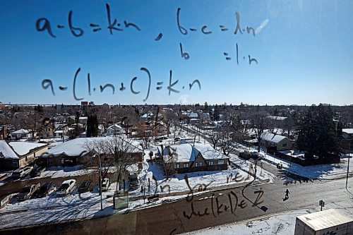 22032023
A formula is written on a window at Brandon University as a pedestrian crosses 18th Street at Louise Avenue on Wednesday.
(Tim Smith/The Brandon Sun)