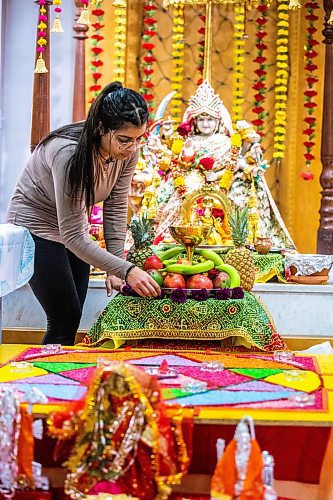 MIKAELA MACKENZIE / WINNIPEG FREE PRESS


Palak Phull prepares the Durga Mata deity altar at the Hindu Temple before the Navratri evening celebration in Winnipeg on Wednesday, March 22, 2023. 
For Romona Goomansingh story.

Winnipeg Free Press 2023.