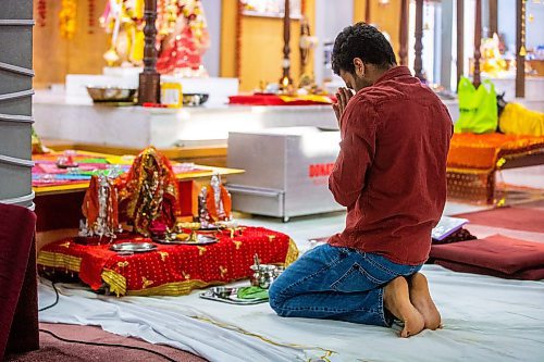 MIKAELA MACKENZIE / WINNIPEG FREE PRESS

Rakesh Chukka pays obeisance to the Durga Mata deity altar at the Hindu Temple before the Navratri evening celebration in Winnipeg on Wednesday, March 22, 2023. 
For Romona Goomansingh story.

Winnipeg Free Press 2023.