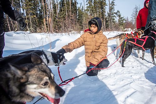 MIKAELA MACKENZIE / WINNIPEG FREE PRESS

Student Harry Jr. Cook pets a sled dog while they take a break on Bloodvein First Nation on Wednesday, March 8, 2023. For Maggie Macintosh story.

Winnipeg Free Press 2023.