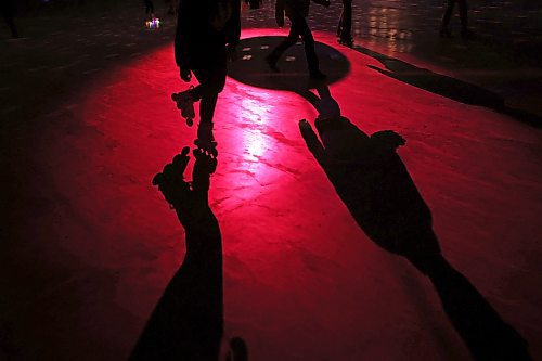 Roller-skaters are silhouetted by the disco lights during Roller Disco at the Sportsplex Arena on Thursday evening. (Tim Smith/The Brandon Sun)