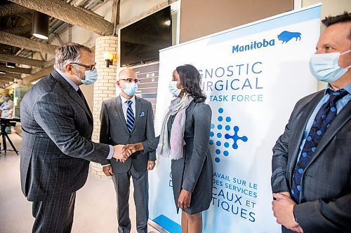 MIKAELA MACKENZIE / WINNIPEG FREE PRESS

Health minister Audrey Gordon shakes hands with Dr. Charles Penner, regional lead of medical services and chief medical officer of the Interlake-Eastern Regional Health Authority (left), as Dr. Chris Christodoulou, cardiac anesthesiologist, and Ryan Amadeo, director of the Pain Clinic, watch after a funding announcement expanding the Manitoba pain program at a press conference at the Health Sciences Centre in Winnipeg on Thursday, March 23, 2023. For Katie/Erik story.

Winnipeg Free Press 2023.