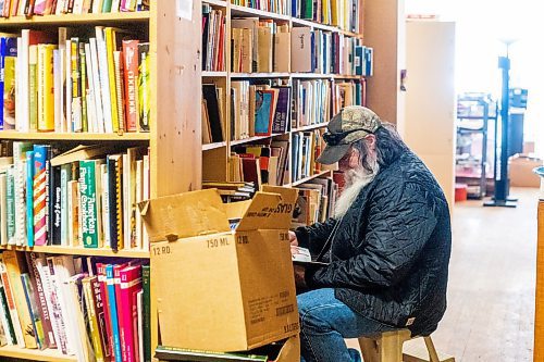MIKAELA MACKENZIE / WINNIPEG FREE PRESS

Kevin Martin browses through horse books for his partner at Nerman&#x573; Books and Collectibles, which is closing down this Saturday after 30 years, in Winnipeg on Thursday, March 23, 2023. For Ben Waldman story.

Winnipeg Free Press 2023.