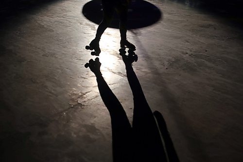23032023
A roller-skater is silhouetted by the disco lights during Roller Disco at the Sportsplex Arena on Thursday evening. The Wheat City Roller derby League was on hand to rent skates to interested roller-skaters without their own pair. Dozens of roller-skating enthusiasts were already in line before the event started and spent the event skating to music under the colourful lights and disco ball. 
(Tim Smith/The Brandon Sun)