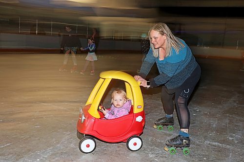 23032023
Brianne Hamilton pushes two-year-old Blake Boyd while roller-skating during Roller Disco at the Sportsplex Arena on Thursday evening. The Wheat City Roller derby League was on hand to rent skates to interested roller-skaters without their own pair. Dozens of roller-skating enthusiasts were already in line before the event started and spent the event skating to music under the colourful lights and disco ball. 
(Tim Smith/The Brandon Sun)