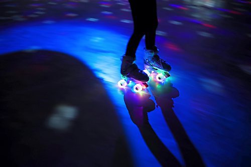 23032023
A roller-skater with glowing wheels skates by during Roller Disco at the Sportsplex Arena on Thursday evening. The Wheat City Roller derby League was on hand to rent skates to interested roller-skaters without their own pair. Dozens of roller-skating enthusiasts were already in line before the event started and spent the event skating to music under the colourful lights and disco ball. 
(Tim Smith/The Brandon Sun)