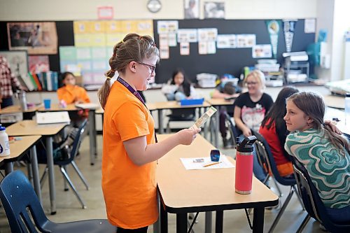 Chloe Mallery, a grade five student in Karissa Kirkup’s grade 5/6 class at Riverview School, reads a card during an Agriculture in the Classroom presentation by volunteer presenter Leanne Sprung on Friday afternoon. (Tim Smith/The Brandon Sun)