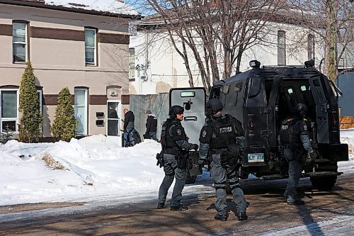 Members of the Brandon Police Service execute a warrant at a home in the 300 block of 11th Street in Brandon on Thursday. (Tim Smith/The Brandon Sun)