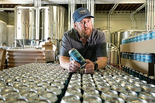RUTH BONNEVILLE / WINNIPEG FREE PRESS 

Biz- Beer Tax

Matt Wolff, Torque Brewing's operations manager with stacks of Torque beer Friday.   Breweries are being hit by a federal tax increase on the processing side of their business.  

March 23rd, 2023