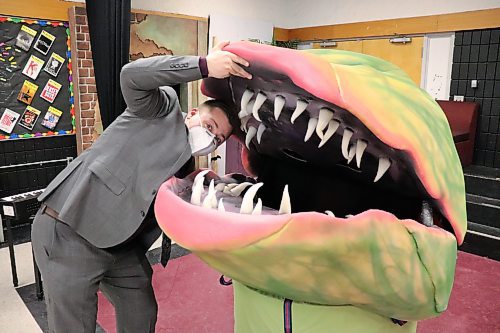 Crocus Plains Regional Secondary School teacher Clint McLachlan highlights the scale of some of the props on display during the school's production of "Little Shop of Horrors" last year. (Kyle Darbyson/The Brandon Sun)