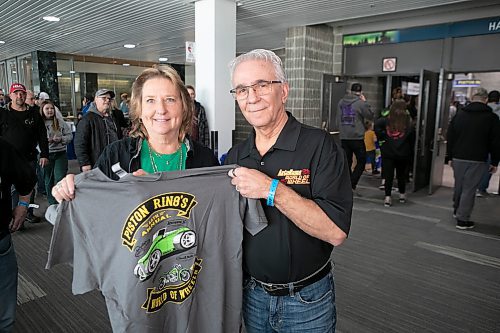 BROOK JONES / WINNIPEG FREE PRESS
Word of Wheels chair Bob Chubala (right) and his wife, Cindy  hold up a Piston Ring's 46th annual World of Wheels T-shirt during the event at the RBC Convention Centre in Winnipeg, Man., Saturday, March 25, 2023. 
