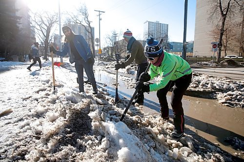 JOHN WOODS / WINNIPEG FREE PRESS
Cyclist Hillary Rosentreter, right, and other cyclists clear an Assiniboine Avenue bike path of ice  Sunday, March 26, 2023. 

Re: Malak