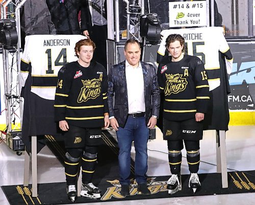 Brandon Wheat Kings owner Jared Jacobson presents graduating players Calder Anderson (14) and Nolan Ritchie (15) with framed jerseys during the team's award presentations as part of their game at Westoba Place on Friday against the Winnipeg iIce. (Perry Bergson/The Brandon Sun)